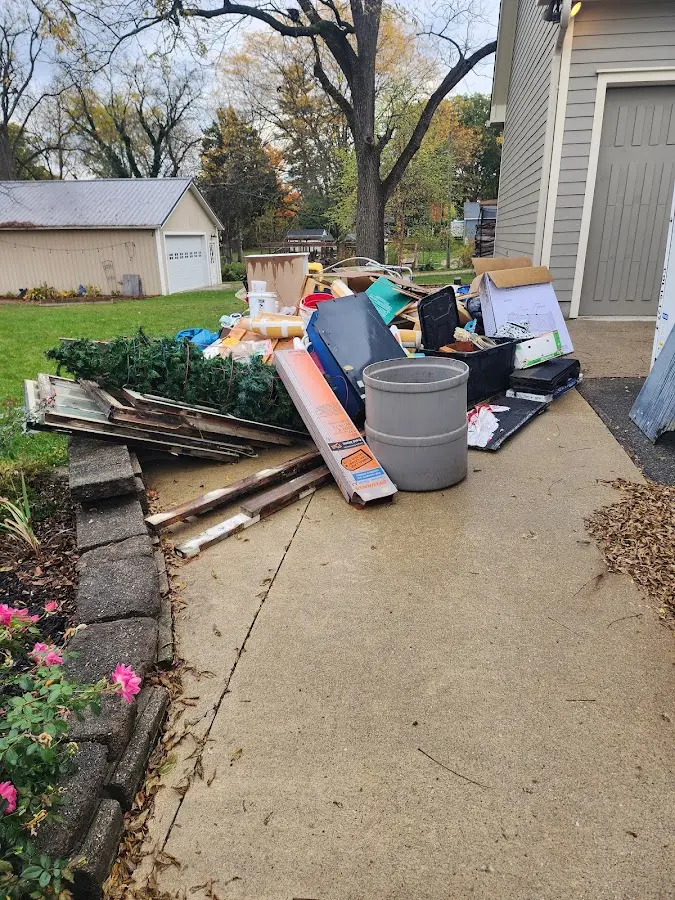 Dumpster being loaded with debris for Residential Dumpster Rental in Mead